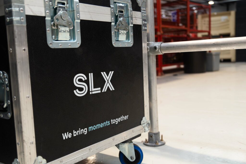 Flight Case with SLX Logo and Strap line: We bring moments together