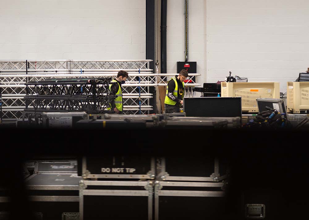 Team working in warehouse preparing equipment